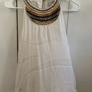 Sleeveless white shirt with beaded collar